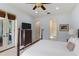 Bright main bedroom featuring light blue walls, a ceiling fan, and direct access to outdoor scenery at 1394 Grove Ter, Winter Park, FL 32789