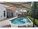 Backyard pool with patio, sun umbrellas, lounge chairs, and privacy landscaping at 1394 Grove Ter, Winter Park, FL 32789