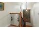Staircase with wood and wrought iron railing featuring decorative wall art at 1394 Grove Ter, Winter Park, FL 32789