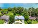 Waterfront home featuring a well-manicured lawn, mature trees, and a circular driveway at 1420 Rock Lake Dr, Orlando, FL 32805