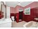 Unique bathroom design featuring tile, a shower, a tub, and red accents at 1420 Rock Lake Dr, Orlando, FL 32805