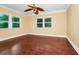 Bright bedroom featuring hardwood floors, a ceiling fan, and lots of natural light at 1420 Rock Lake Dr, Orlando, FL 32805