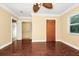 Bedroom featuring hardwood floors, large closet, and natural light from windows at 1420 Rock Lake Dr, Orlando, FL 32805