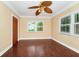 Bright bedroom with hardwood floors, windows, and a unique ceiling fan at 1420 Rock Lake Dr, Orlando, FL 32805