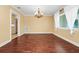 Inviting dining room featuring hardwood floors, traditional chandelier, and bright natural light at 1420 Rock Lake Dr, Orlando, FL 32805