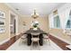 Staged dining room with modern decor, featuring hardwood floors, chandelier, and bright natural light at 1420 Rock Lake Dr, Orlando, FL 32805