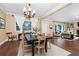 Elegant dining room featuring hardwood floors, chandelier, and seamlessly connected to living room at 1420 Rock Lake Dr, Orlando, FL 32805