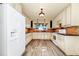 Updated kitchen featuring tile floors, light cabinets, stone countertops, and stainless appliances at 1420 Rock Lake Dr, Orlando, FL 32805