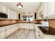 Updated kitchen featuring tile floors, light cabinets, stone countertops, and stainless appliances at 1420 Rock Lake Dr, Orlando, FL 32805