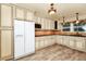 Bright kitchen featuring tile floors, light cabinets, stone countertops, and stainless appliances at 1420 Rock Lake Dr, Orlando, FL 32805