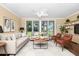 Cozy living room with a ceiling fan, hardwood floors, and lots of natural light at 1420 Rock Lake Dr, Orlando, FL 32805