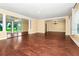 Open-concept living space featuring hardwood floors, decorative columns, and seamless flow to the outdoor at 1420 Rock Lake Dr, Orlando, FL 32805