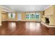 Spacious living room with a fireplace, natural light, and hardwood floors at 1420 Rock Lake Dr, Orlando, FL 32805