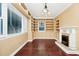 Living room with built-in shelving, a fireplace, and natural light at 1420 Rock Lake Dr, Orlando, FL 32805