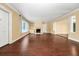 Expansive living area with hardwood floors, classic fireplace, and built-in shelving at 1420 Rock Lake Dr, Orlando, FL 32805