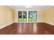 Large, bright bonus room with hardwood floors, a ceiling fan, and a glass patio door at 1420 Rock Lake Dr, Orlando, FL 32805