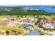 Aerial view of the community with a golf course and lake in the distance, perfect for outdoor recreation! at 16210 Ravenna Ct, Montverde, FL 34756