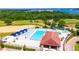 An aerial photograph showcases a resort style pool with lounge seating, complemented by golf course and lake views at 16210 Ravenna Ct, Montverde, FL 34756