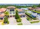 An aerial view of the home, community pool, parking, manicured lawns, and surrounding landscape at 16210 Ravenna Ct, Montverde, FL 34756