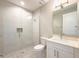 Modern bathroom featuring a tiled shower with glass door, toilet and vanity at 16210 Ravenna Ct, Montverde, FL 34756
