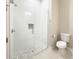 Modern bathroom features include a glass shower with sleek, wave-patterned tile and neutral mosaic flooring at 16210 Ravenna Ct, Montverde, FL 34756