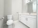 Bathroom features a toilet, sink with white vanity, and modern fixtures at 16210 Ravenna Ct, Montverde, FL 34756