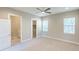 Inviting bedroom with a ceiling fan, access to a walk-in closet, and an ensuite bathroom at 16210 Ravenna Ct, Montverde, FL 34756