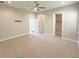 Comfortable bedroom featuring plush carpet, a ceiling fan, and easy access to closets and doorways at 16210 Ravenna Ct, Montverde, FL 34756