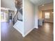 Inviting entryway with hardwood floors, a staircase, and open doorway leading to other rooms at 16210 Ravenna Ct, Montverde, FL 34756