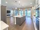 Contemporary kitchen showcasing a central island, stainless steel appliances, and sliding doors to the backyard at 16210 Ravenna Ct, Montverde, FL 34756