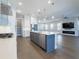 Modern kitchen featuring a center island, stainless steel appliances, white cabinetry, and an open floor plan at 16210 Ravenna Ct, Montverde, FL 34756