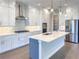 Stylish kitchen with white cabinetry, stainless steel appliances, tiled backsplash, and a functional center island at 16210 Ravenna Ct, Montverde, FL 34756