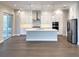 Well-lit kitchen featuring modern appliances, a center island with seating, and ample storage space at 16210 Ravenna Ct, Montverde, FL 34756