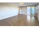 Expansive living room with a sliding glass door leading to an outdoor area, illuminated by a modern light fixture at 16210 Ravenna Ct, Montverde, FL 34756