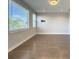 Bright living room includes large windows with treetop views and a modern light fixture at 16210 Ravenna Ct, Montverde, FL 34756