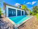 A backyard pool offers refreshing relaxation near sliding glass doors with a screened lanai overlooking a lush outdoor space at 16210 Ravenna Ct, Montverde, FL 34756