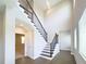 Elegant staircase with dark wood treads and railing, bright walls, and hardwood floors at 16210 Ravenna Ct, Montverde, FL 34756