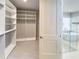 Bright walk-in closet with custom shelving and glass-enclosed shower in adjacent bathroom at 16210 Ravenna Ct, Montverde, FL 34756