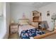 Cozy bedroom with a twin bed, a desk with storage shelves, and a window with blinds at 1956 Southern Dunes Blvd, Haines City, FL 33844