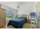 Bedroom with neutral walls, a view of the backyard, and side tables with lamps at 1956 Southern Dunes Blvd, Haines City, FL 33844