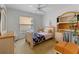 Bright bedroom featuring a twin bed, desk with built-ins, and natural light from the window at 1956 Southern Dunes Blvd, Haines City, FL 33844