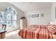 Bedroom with vaulted ceiling, large picture window, two twin beds, and light colored carpet at 1956 Southern Dunes Blvd, Haines City, FL 33844