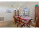 Dining room with table set for six under chandelier, arched window, and wooden hutch at 1956 Southern Dunes Blvd, Haines City, FL 33844