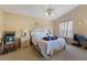 Cozy primary bedroom with neutral paint, ceiling fan, and large window for natural light at 1956 Southern Dunes Blvd, Haines City, FL 33844