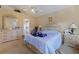 Cozy primary bedroom with neutral paint, ceiling fan, and large window for natural light at 1956 Southern Dunes Blvd, Haines City, FL 33844