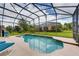 Beautiful backyard swimming pool with a spacious deck and lush green landscaping at 1956 Southern Dunes Blvd, Haines City, FL 33844