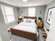 Stylishly furnished bedroom with wood-look floors, area rug, and accent lighting at 2107 Hollywood Ave, Eustis, FL 32726