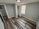 Neutral bedroom with laminate floors, closet, and bright natural light at 2107 Hollywood Ave, Eustis, FL 32726
