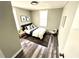 Small bedroom with wood-look floors, area rug, and modern decor at 2107 Hollywood Ave, Eustis, FL 32726