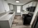 Modern kitchen with stainless steel appliances, white cabinets, and light countertops at 2107 Hollywood Ave, Eustis, FL 32726